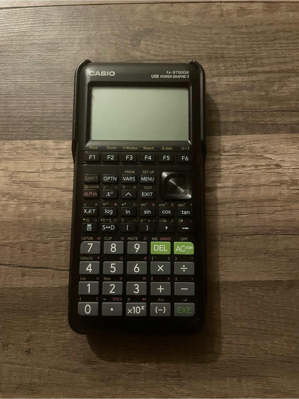 Calculator on Wooden Surface